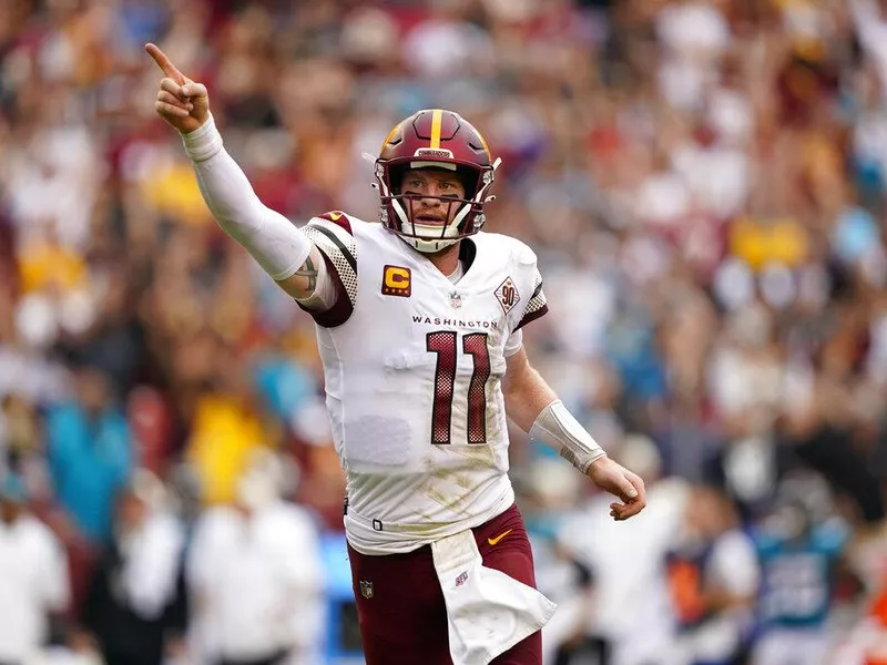 Washington Commanders quarterback Carson Wentz celebrates