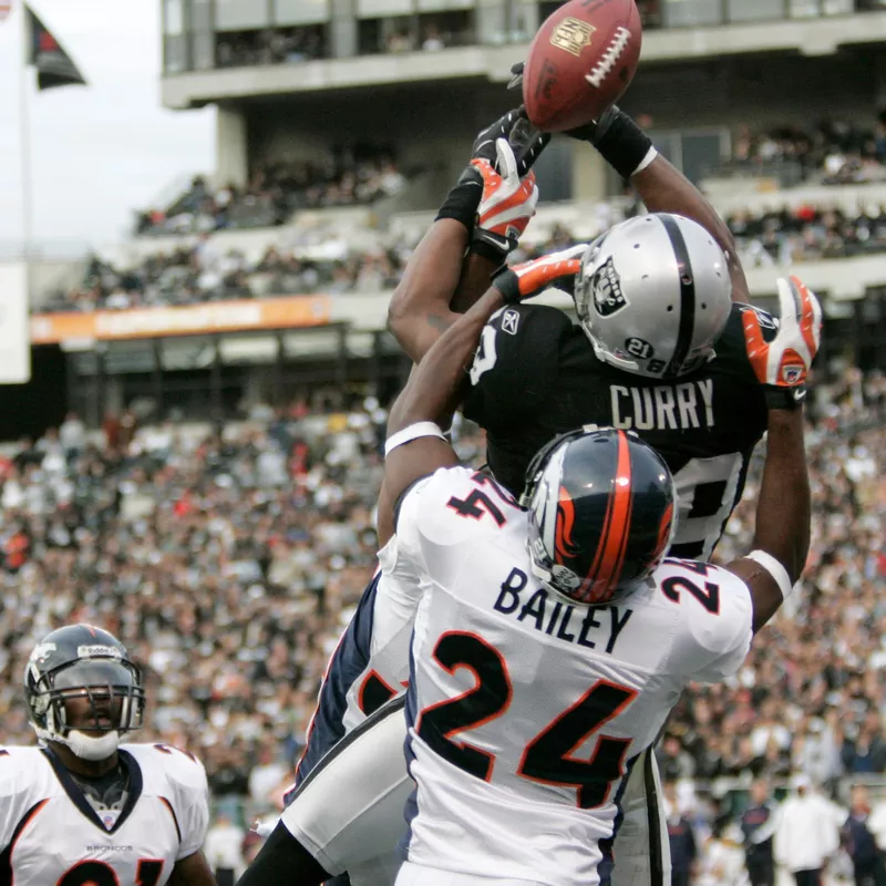Ronald Curry and Champ Bailey going for football