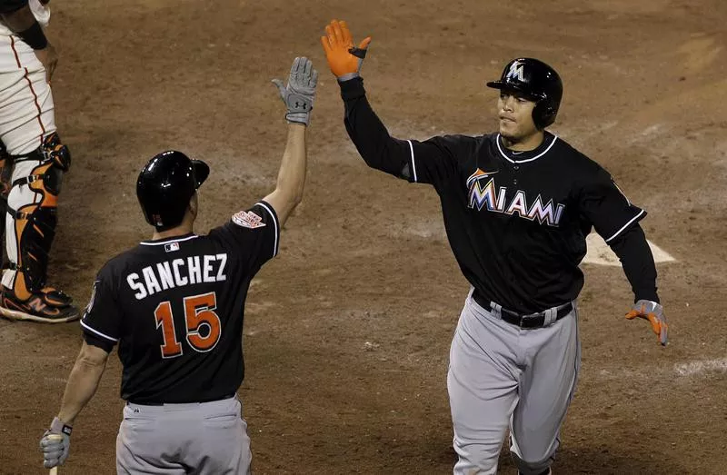 Giancarlo Stanton celebrates with Gaby Sanchez