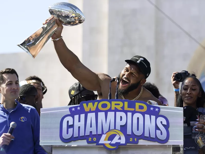 Aaron Donald holds up Vince Lombardi Super Bowl trophy