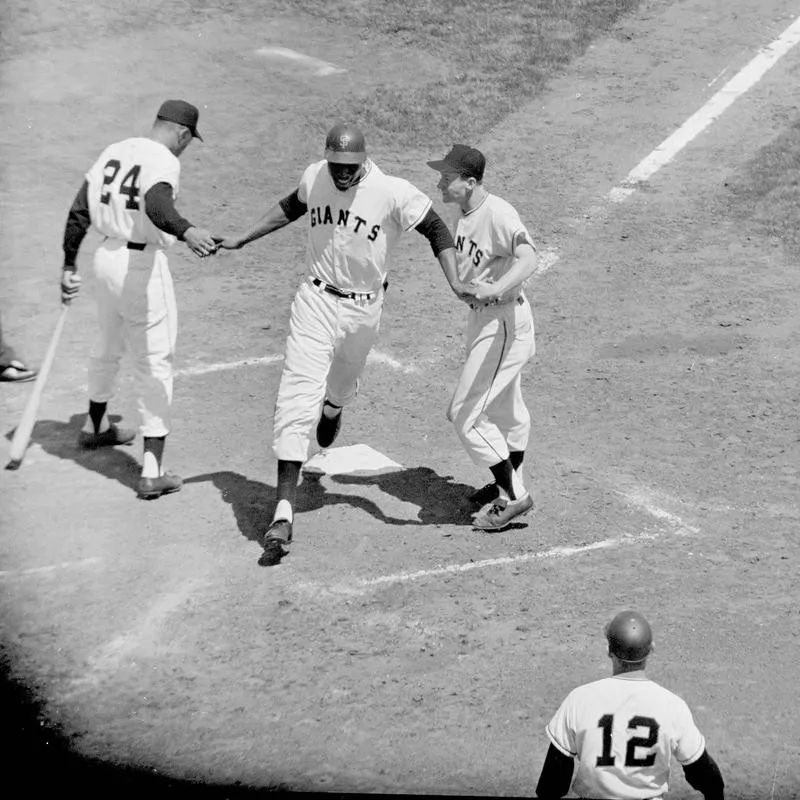 Willie McCovey congratulated by Willie Mays