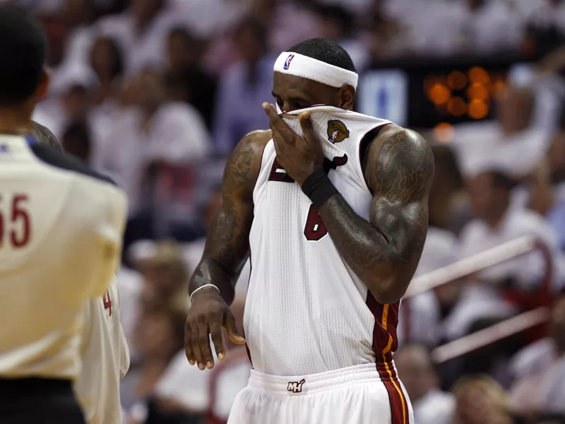 Miami Heat's LeBron James wipes brow against Dallas Mavericks