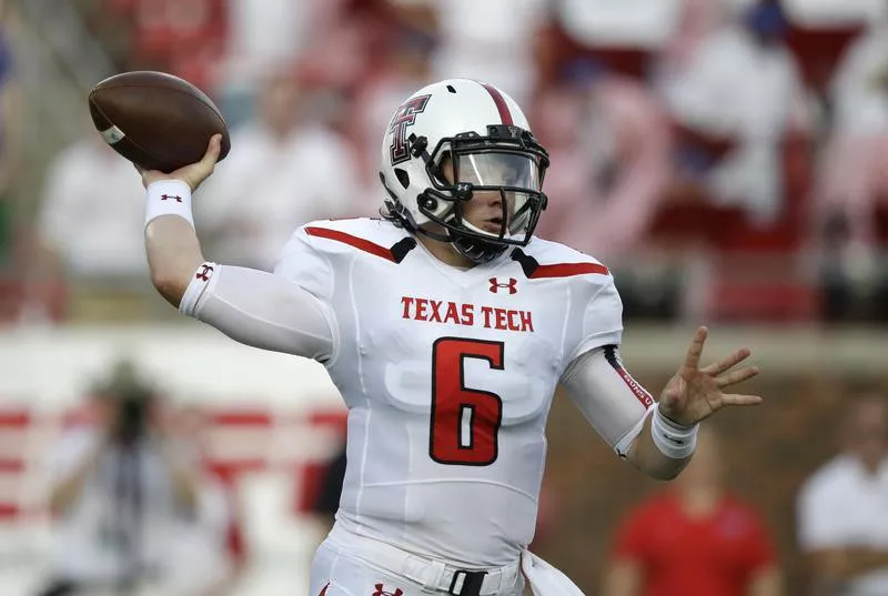 Baker Mayfield passes during first half