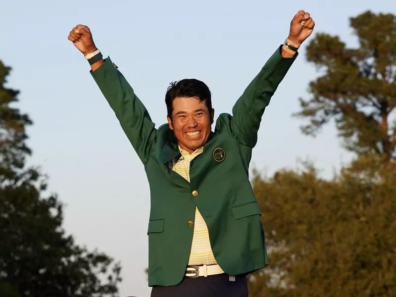 Hideki Matsuyama celebrates after putting on champion's green jacket after winning Masters