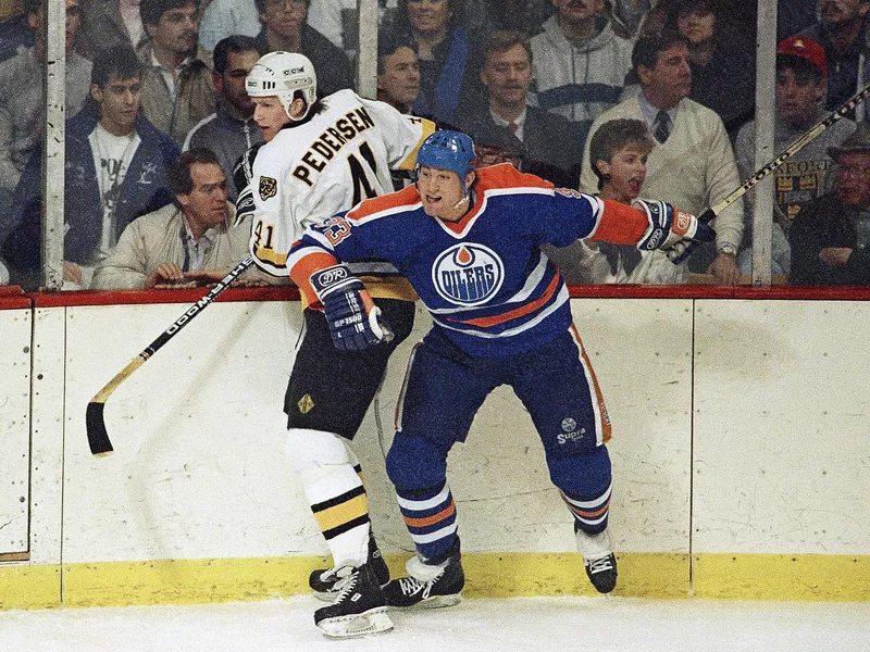 Marty McSorley checks Allen Pederson into the boards