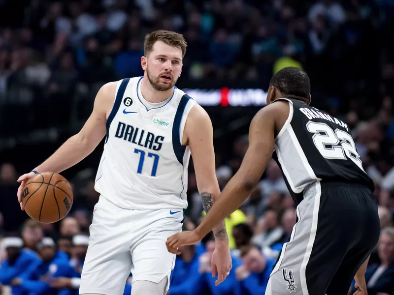 Dallas Mavericks guard Luka Doncic looks to make a move against San Antonio Spurs guard Malaki Branham