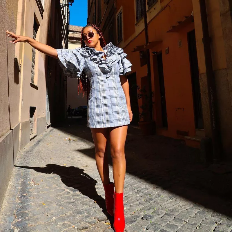 Naomi Osaka posing against wall