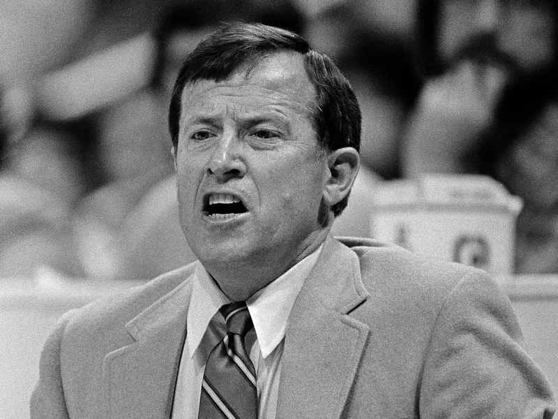 Dallas Maverick head coach Dick Motta bites his tongue