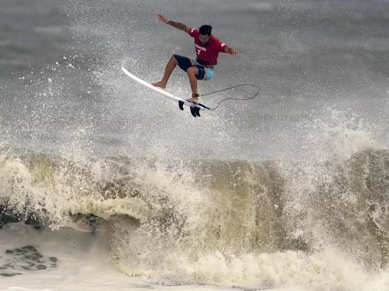 Brazil's Italo Ferreira goes to air on wave during semifinals