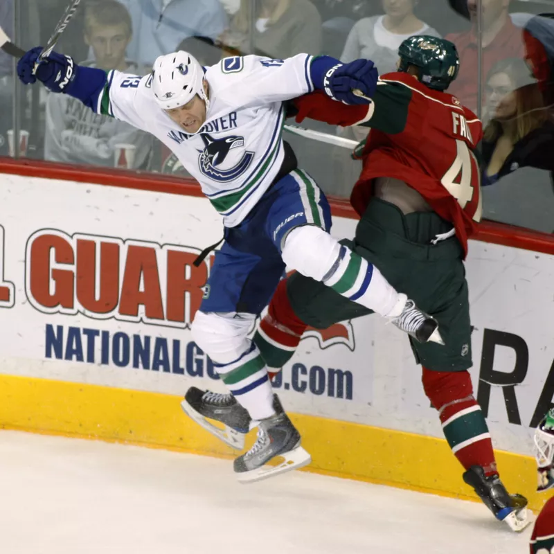 Raffi Torres checked by Minnesota Wild defenseman Justin Falk