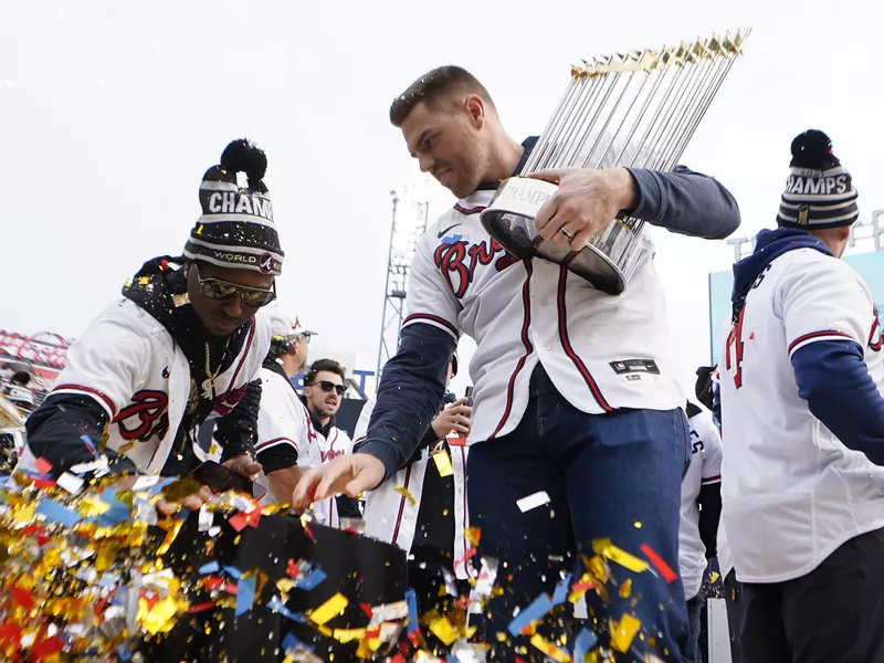 Atlanta Braves first baseman Freddie Freeman holding Commissioner's Trophy