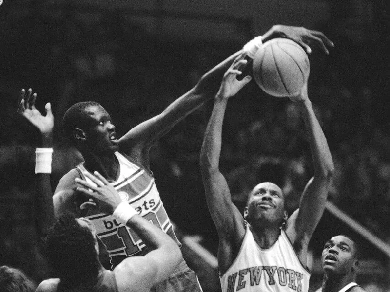 Manute Bol blocks shot by Darrell Walker