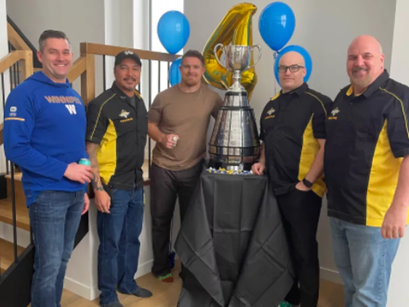 People posing with Grey Cup