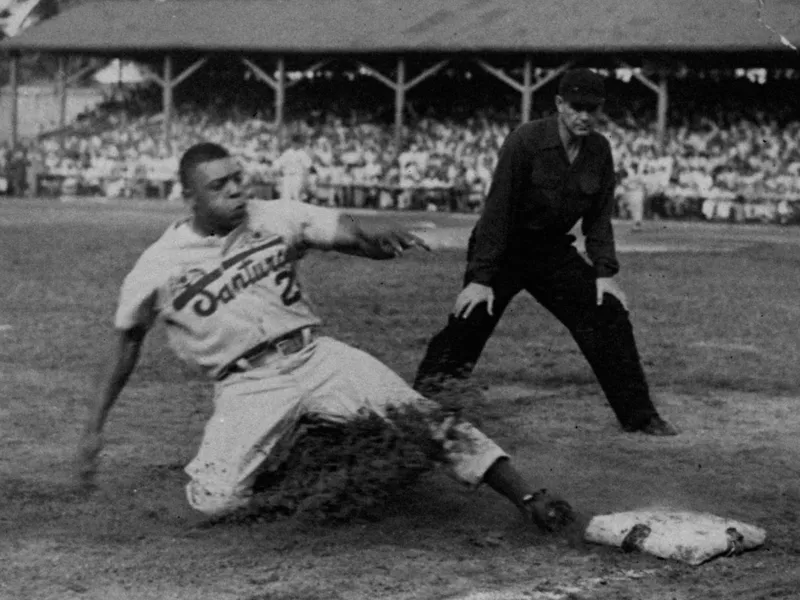 New York Giants' Willie Mays sliding into third base