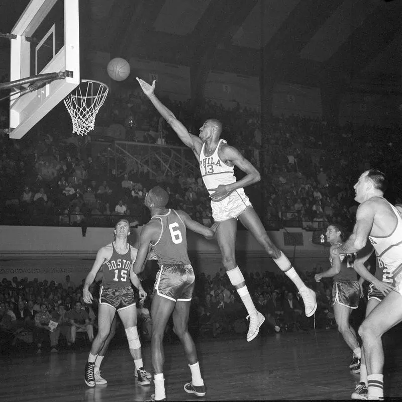 Wilt Chamberlain taps ball in