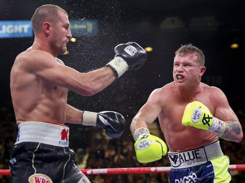 Sergey Kovalev and Canelo Alvarez exchange punches