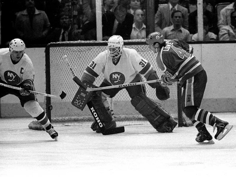 New York Islanders goalie Billy Smith blocks shot by Kevin Lowe