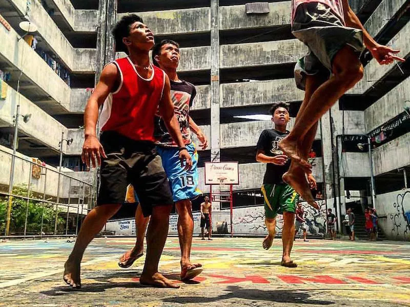 Boys play basketball at the Taguig Tenement