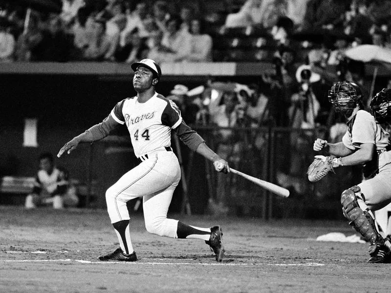 Atlanta Braves' Hank Aaron watches flight of his long ball