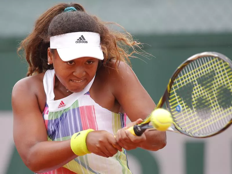 Naomi Osaka hitting a backhand