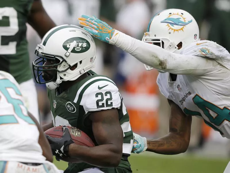 New York Jets cornerback Ed Reed runs with ball after intercepting pass