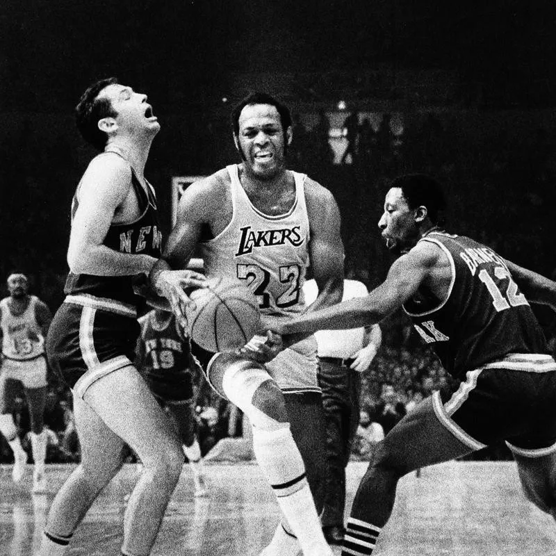 Los Angeles Lakers' Elgin Baylor maneuvers his way through New York Knicks' Bill Bradley