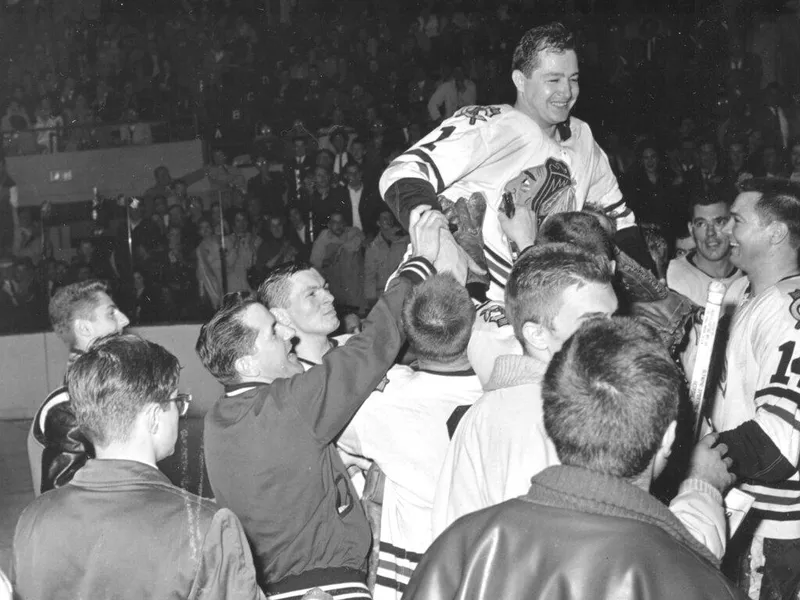 Glenn Hall celebrates with his hockey teammates