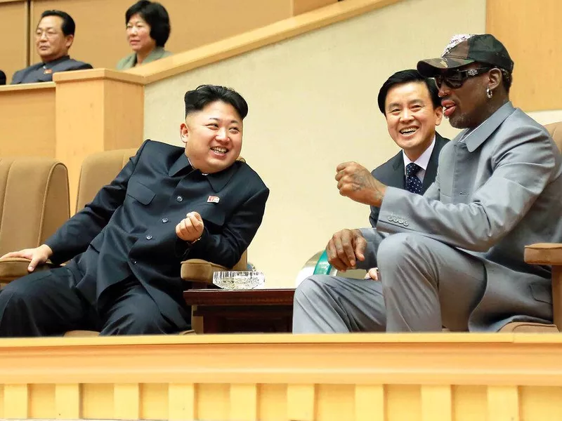 North Korean leader Kim Jong Un, left, talks with former NBA player Dennis Rodman, right