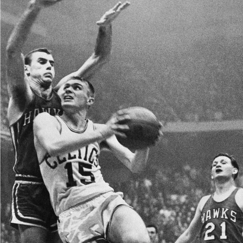 Tommy Heinsohn drives against Bob Pettit