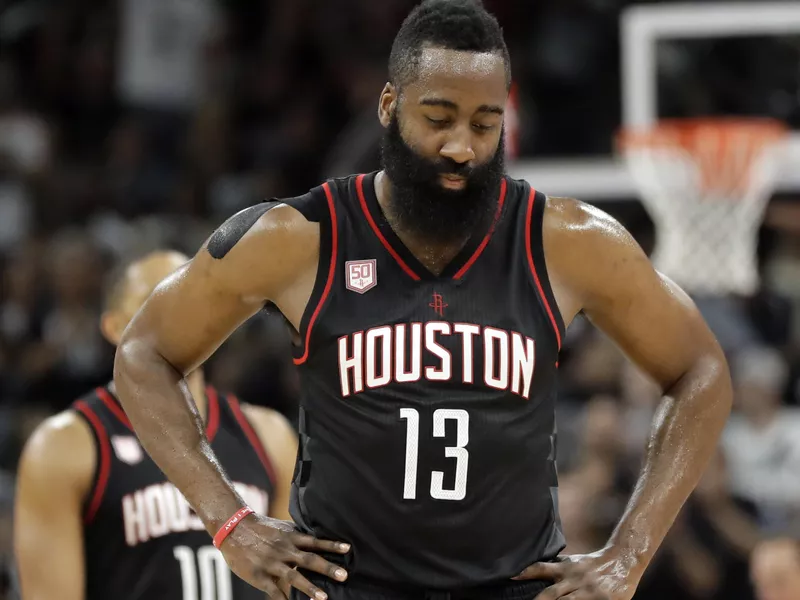 Houston Rockets' James Harden walks to bench