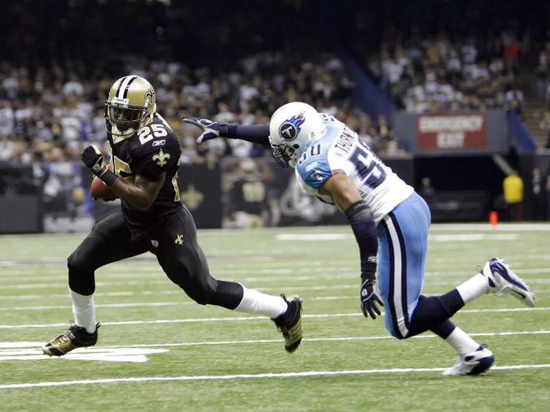 New Orleans Saints Reggie Bush avoids tackle Tennessee Titans David Thornton's tackle