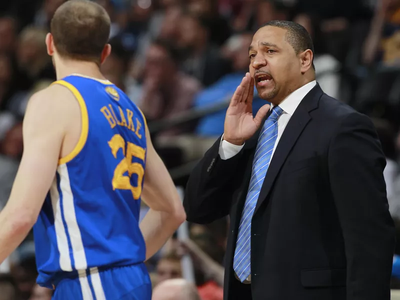 Golden State Warriors head coach Mark Jackson confers with guard Steve Blake