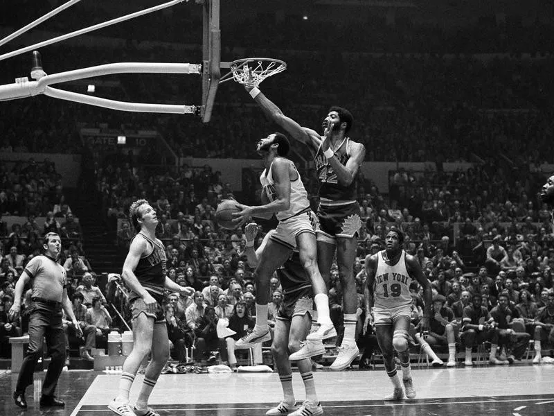 Walt Frazier goes up to basket