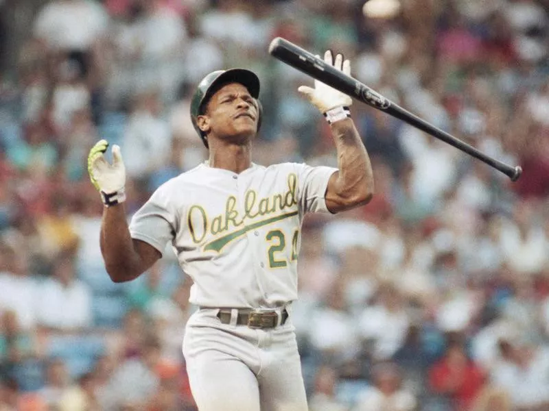 Rickey Henderson reacts with bat