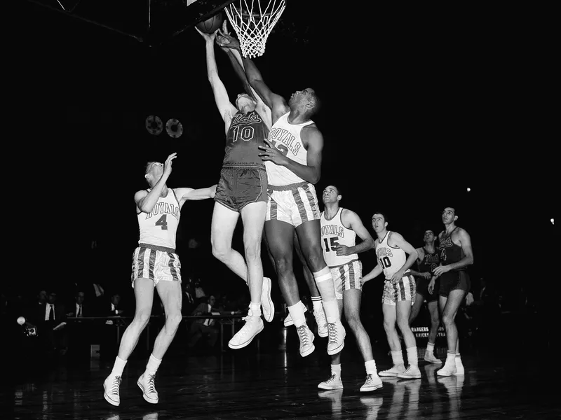 Maurice Stokes leaps to grab rebound from John Kerr