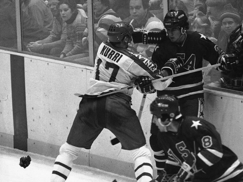 Jari Kurri pushing David Christian against boards