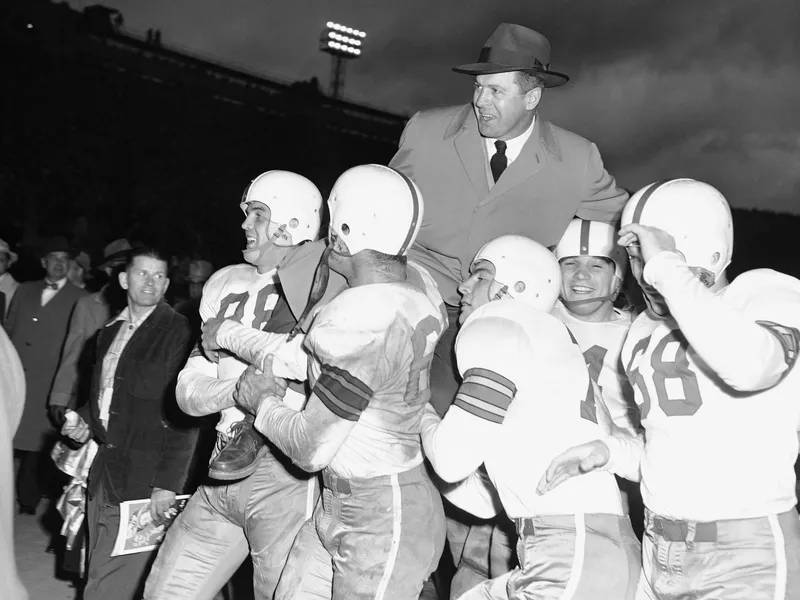 Ohio State coach Wes Fesler gets carried by players after winning the 1950 Rose Bowl against California