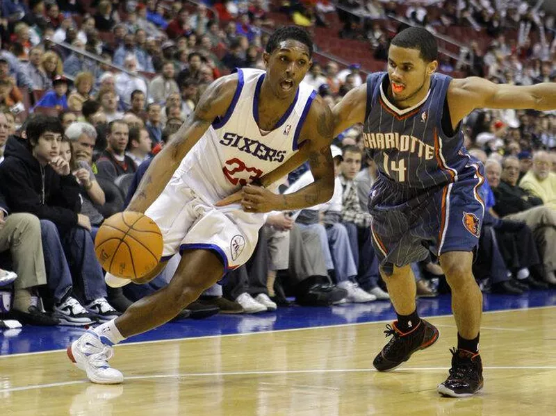 Lou Williams drives past D.J. Augustin