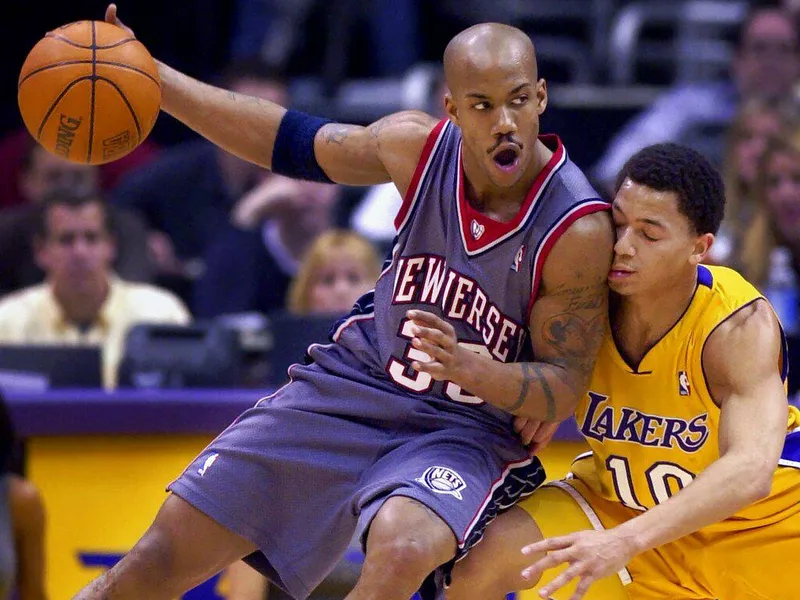 New Jersey Nets' Stephon Marbury, left, shoulders into Los Angeles Lakers' Tyronn Lue