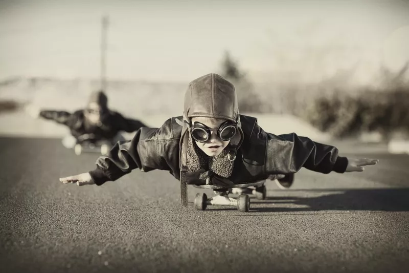 Kids riding skateboards in the 20th century