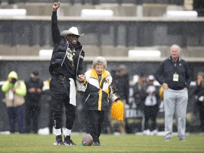 Colorado head coach Deion Sanders and fan Peggy Coppom