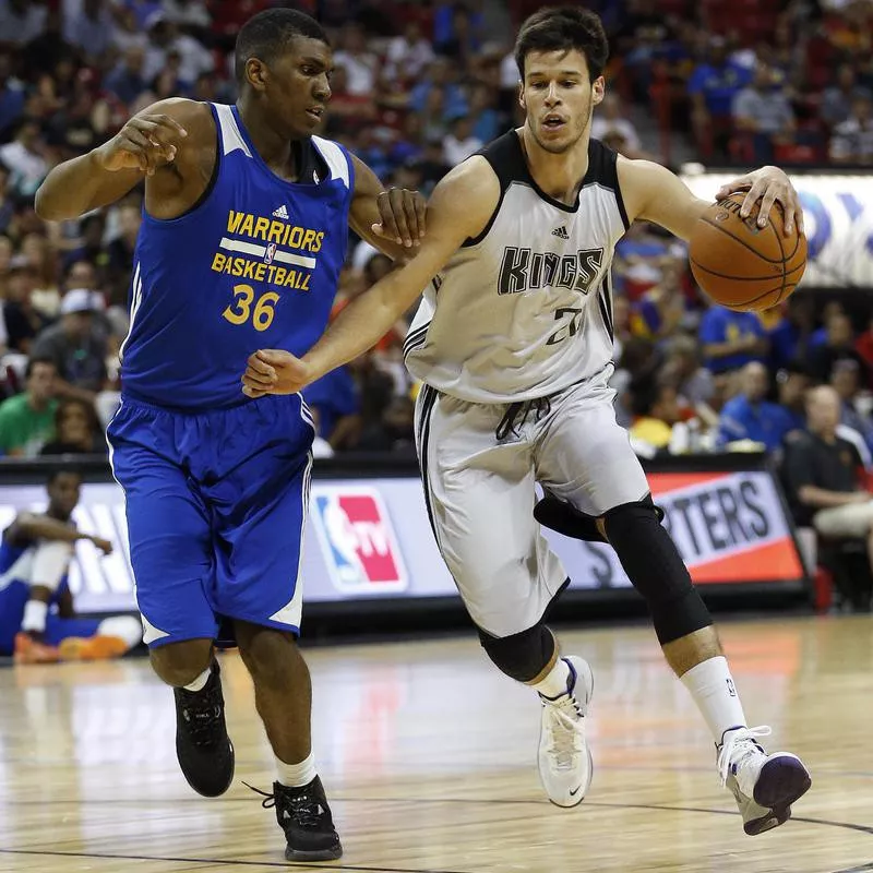 Sacramento Kings’ Duje Dukan drives around Golden State Warriors’ Kevon Looney