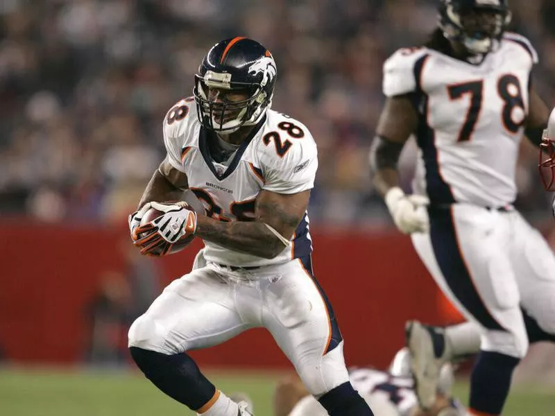 Denver Broncos running back Michael Pittman runs with ball