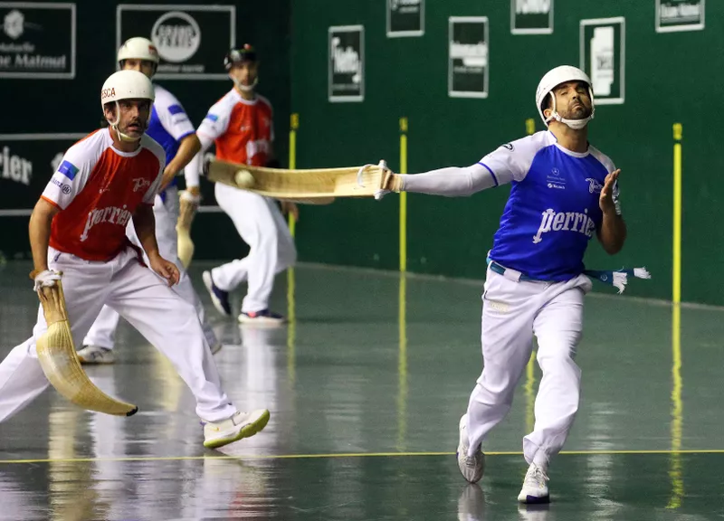 Competitor in action in Basque pelota game