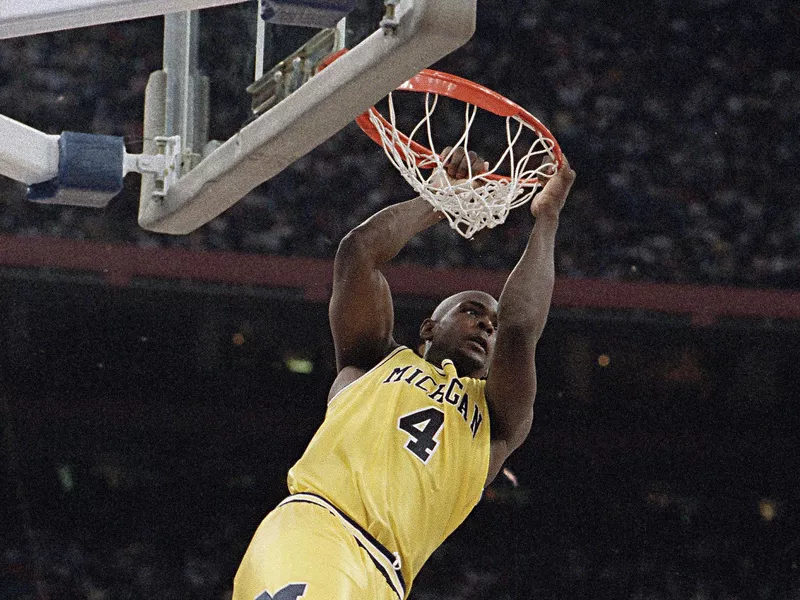 Michigan's Chris Webber hangs from rim