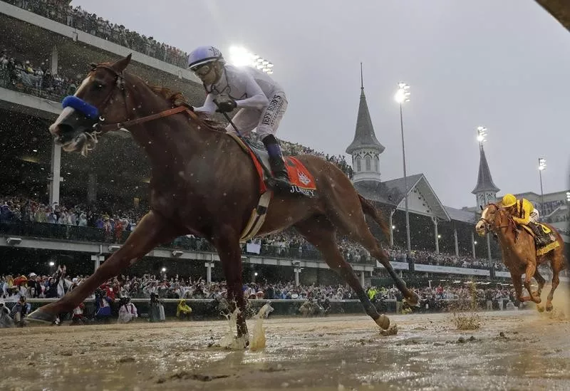 Justify, ridden by jockey Mike Smith, winning 2018 Kentucky Derby