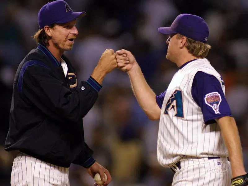 Curt Schilling receives fist bump from teammate Randy Johnson