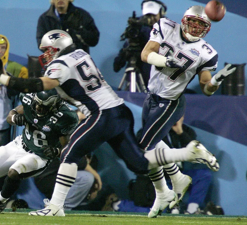 New England Patriots safety Rodney Harrison intercepts pass