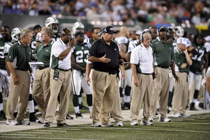 Rex Ryan on the sidelines with New York Jets players and staff during game against New York Giants