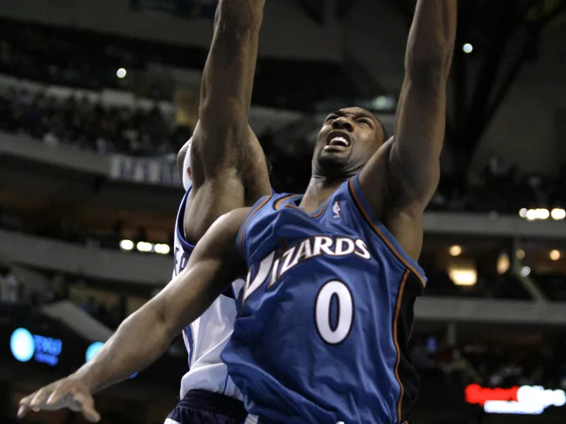 Washington Wizards guard Gilbert Arenas attempts shot over Dallas Mavericks Erick Dampie